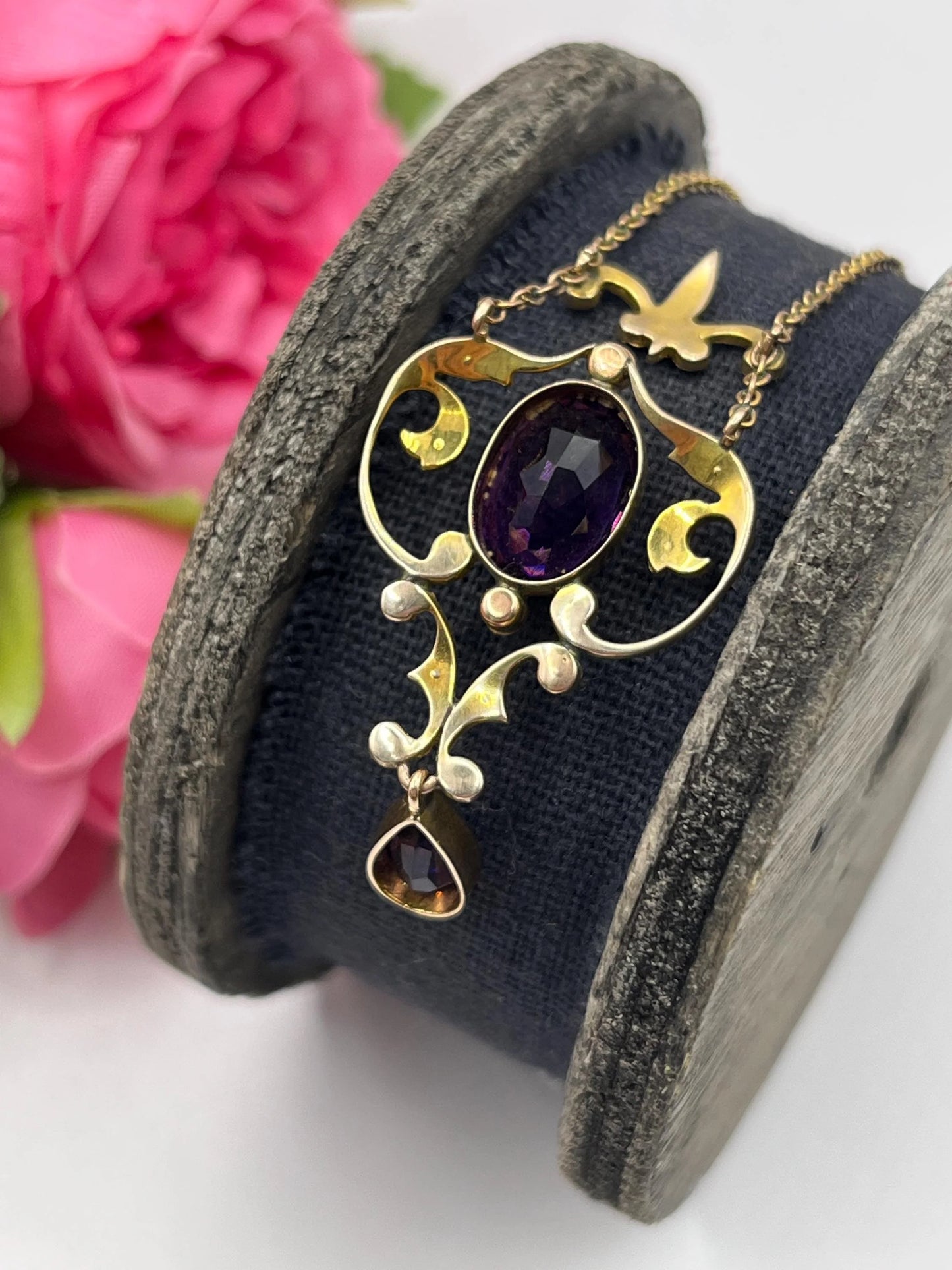 An amethyst and seed pearl pendant necklace in yellow gold