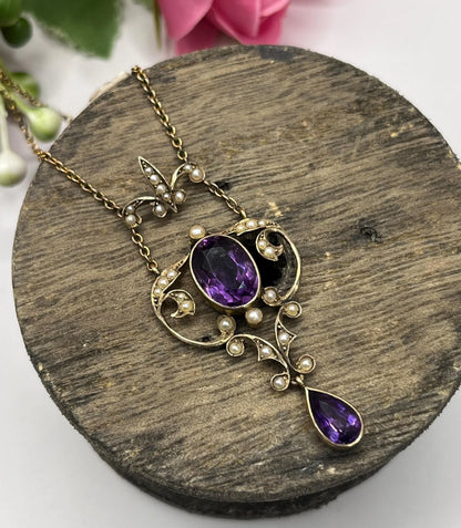 An amethyst and seed pearl pendant necklace in yellow gold