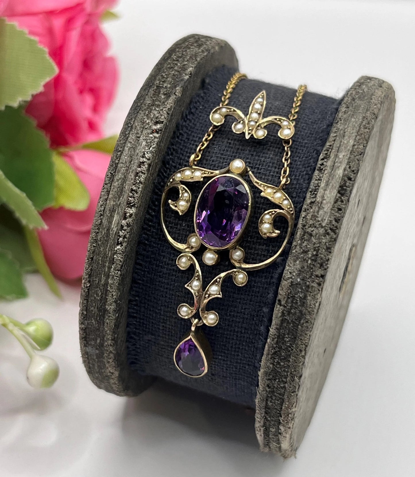 An amethyst and seed pearl pendant necklace in yellow gold