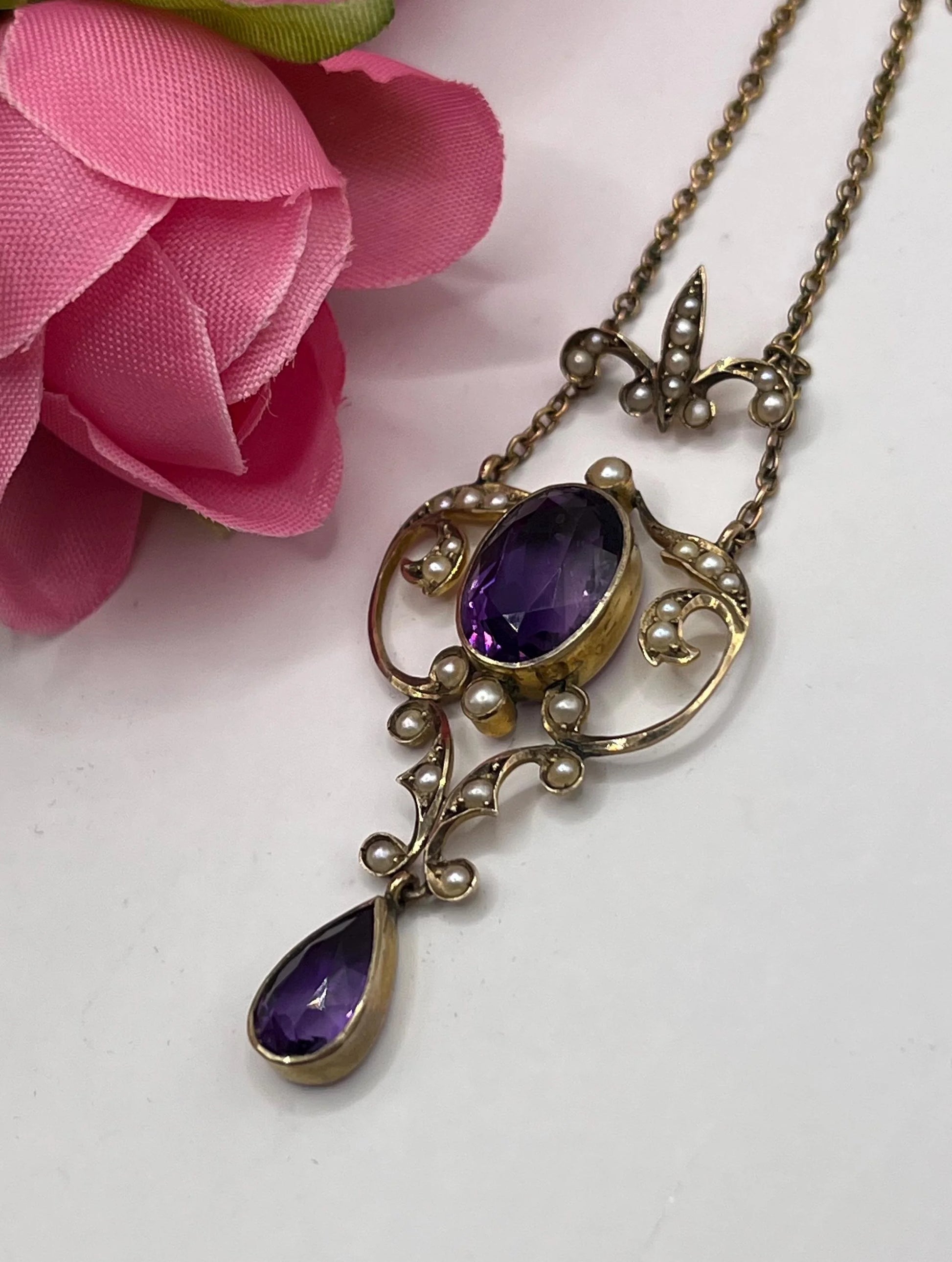An amethyst and seed pearl pendant necklace in yellow gold