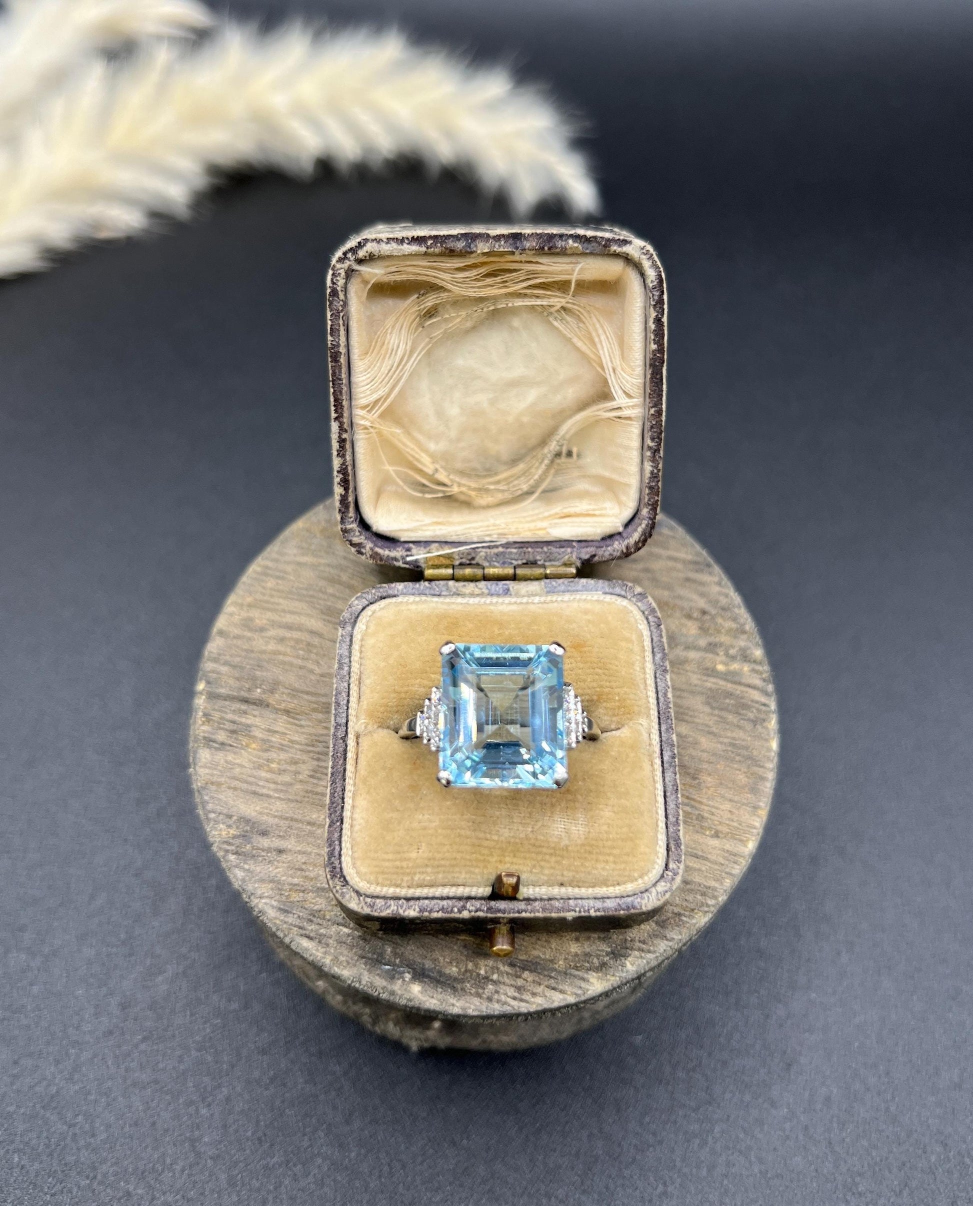 A large aquamarine and diamond dress ring in platinum, in a ring box