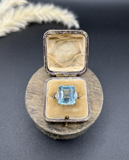 A large aquamarine and diamond dress ring in platinum, in a ring box