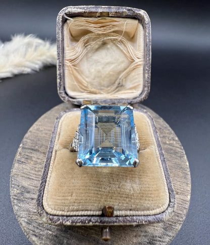 A large aquamarine and diamond dress ring in platinum, in a ring box