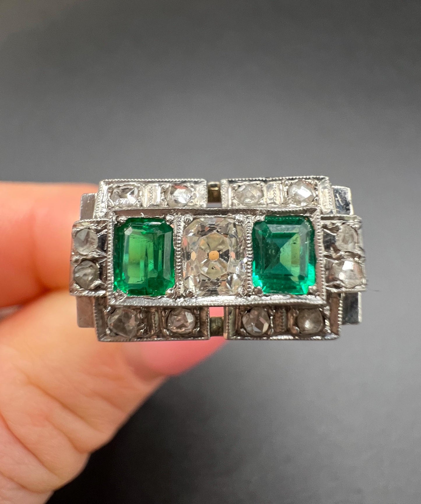 An emerald and old cut diamond rectangular ring in platinum