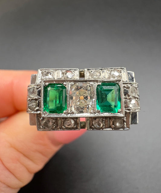 An emerald and old cut diamond rectangular ring in platinum
