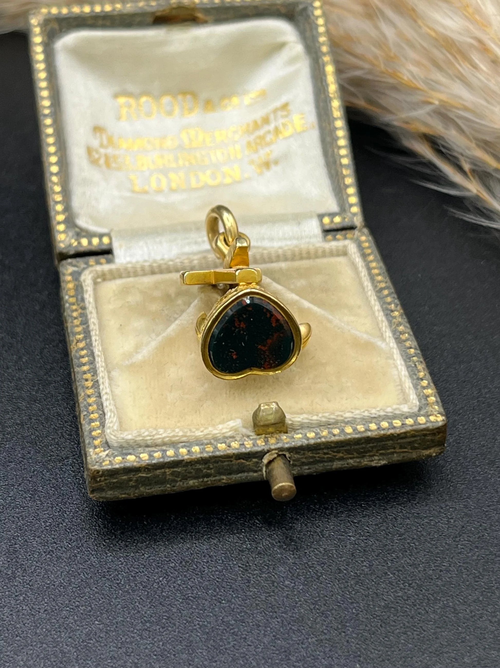 A yellow gold faith, hope and charity fob, with a heart-shaped bloodstone base