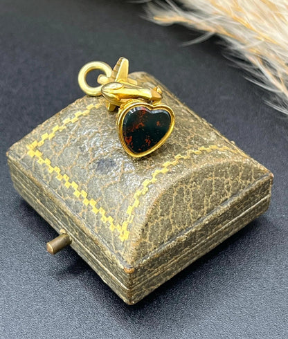 A yellow gold faith, hope and charity fob, with a heart-shaped bloodstone base
