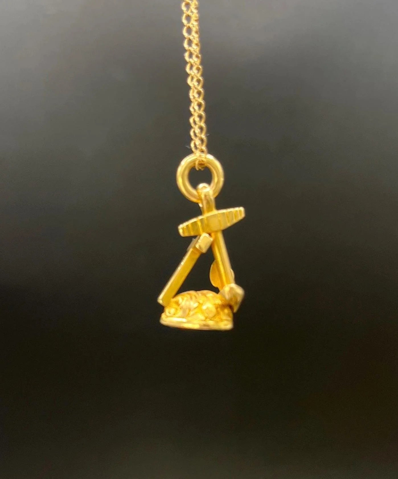 A yellow gold faith, hope and charity fob, with a gold chain