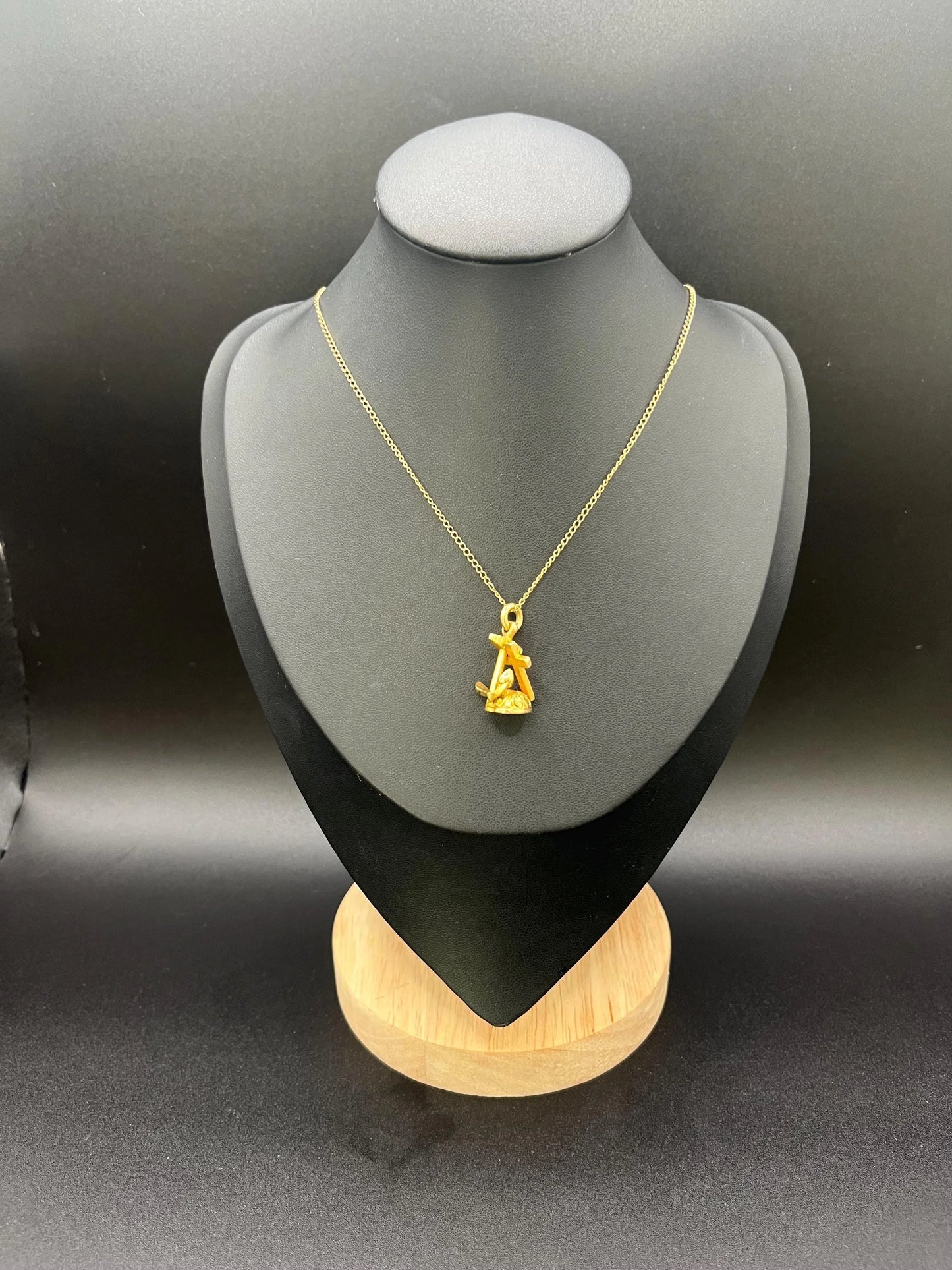 A yellow gold faith, hope and charity fob, with a gold chain
