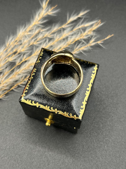 A yellow gold ruby and diamond set double headed snake ring