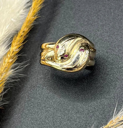 A yellow gold ruby and diamond set double headed snake ring