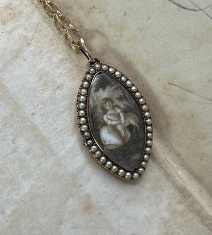 A navette shaped yellow gold seed pearl pendant with a miniature portrait, with a chain