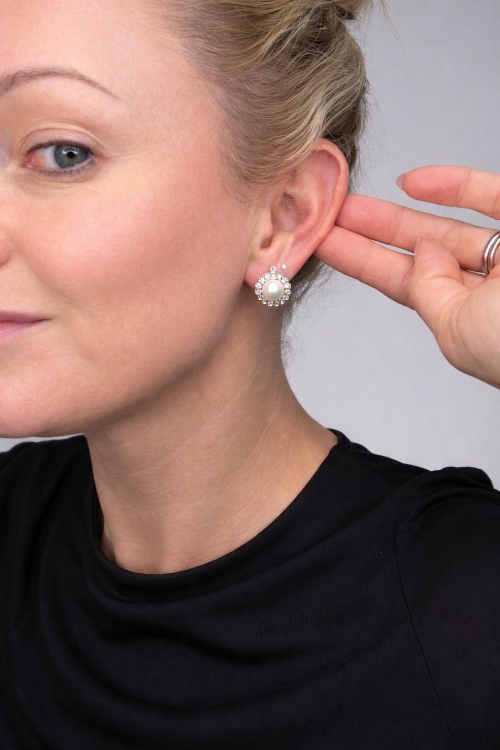 A pearl and old cut diamond floral cluster earring, modelled in an ear