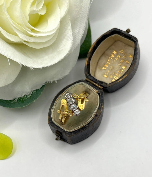A four stone old cut diamond ring in yellow and white gold, in an antique ring box