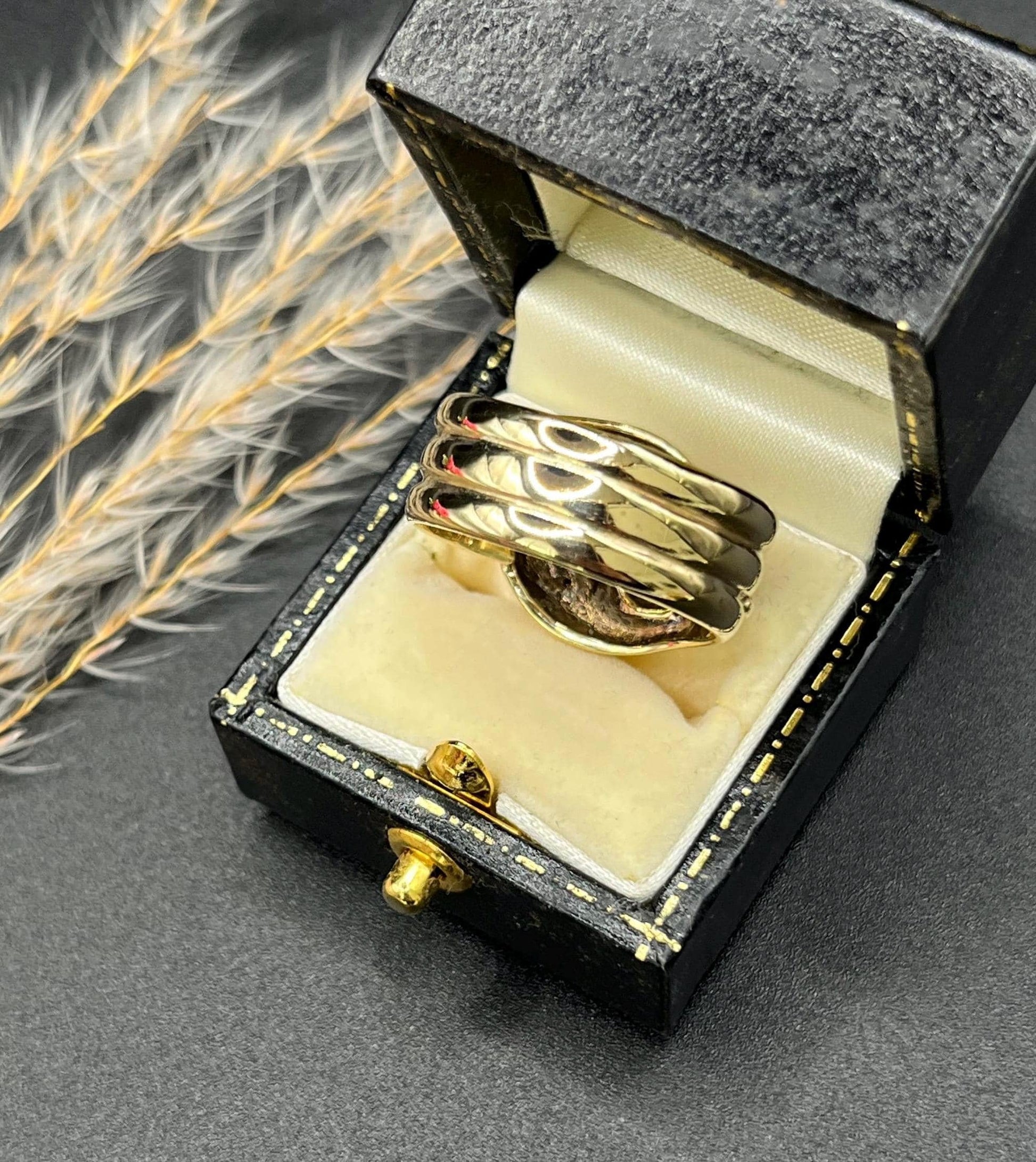 A yellow gold ruby and diamond set double headed snake ring, in a ring box