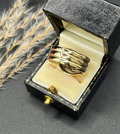 A yellow gold ruby and diamond set double headed snake ring, in a ring box
