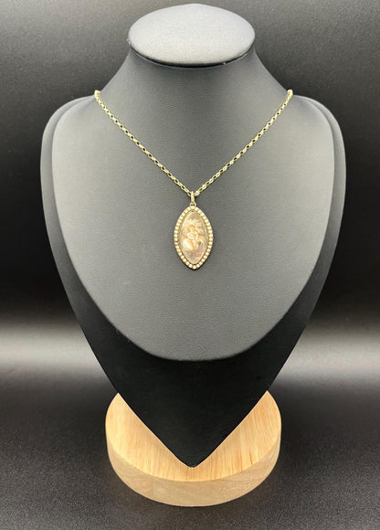 A navette shaped yellow gold seed pearl pendant with a miniature portrait, with a chain, on a black jewellery bust
