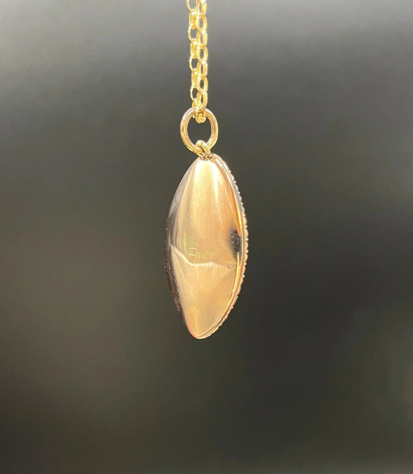 A navette shaped yellow gold seed pearl pendant, with a chain