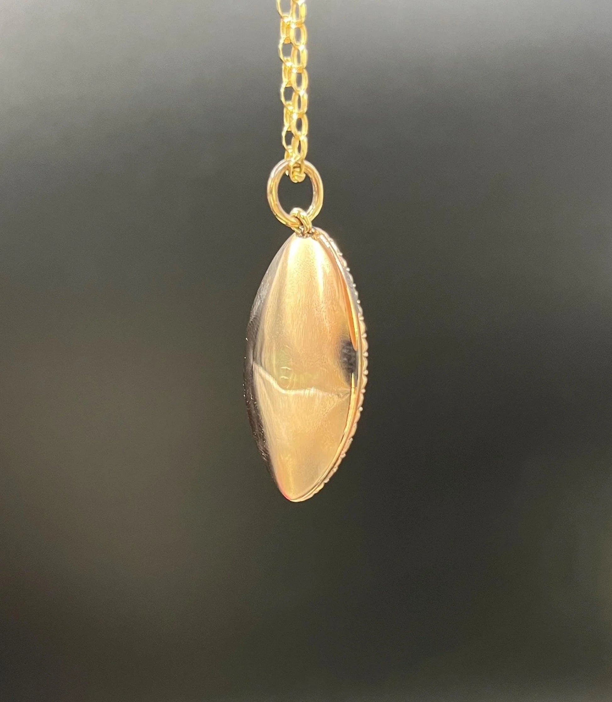 A navette shaped yellow gold seed pearl pendant, with a chain