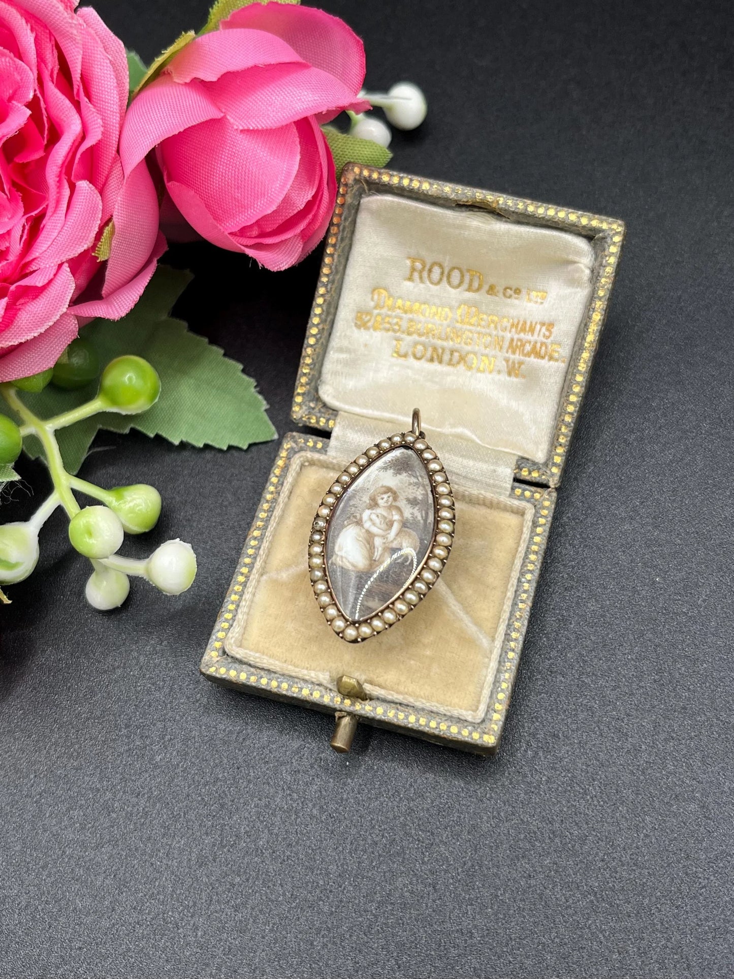 A navette shaped yellow gold seed pearl pendant with a miniature portrait, in an antique box