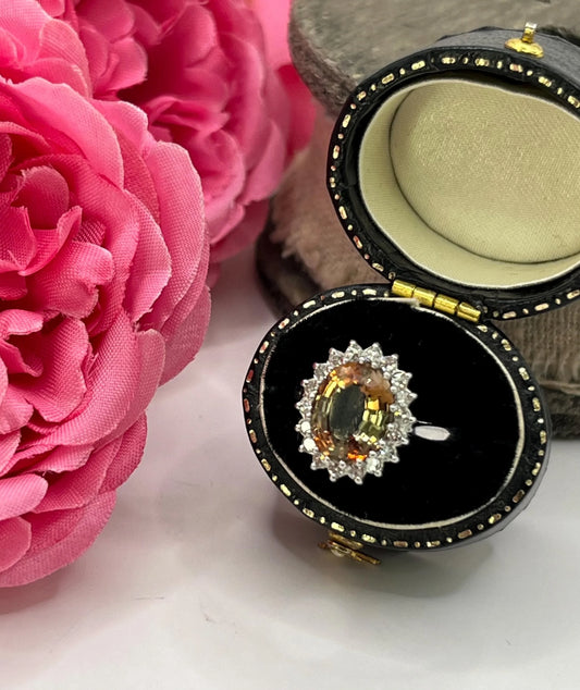 An oval tourmaline and diamond cluster ring in white gold, in a ring box