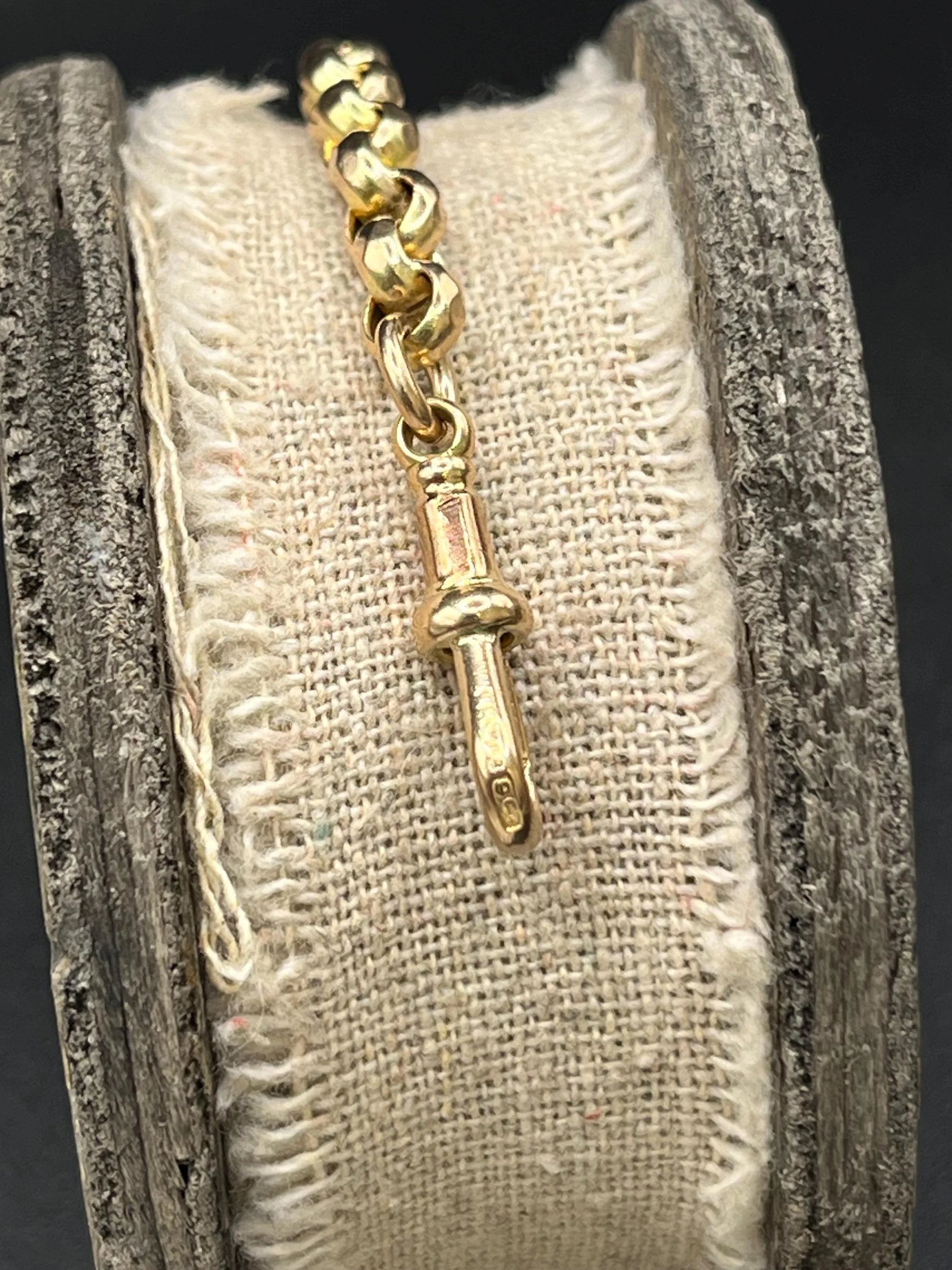 A yellow gold round link bracelet with a lobster claw clasp