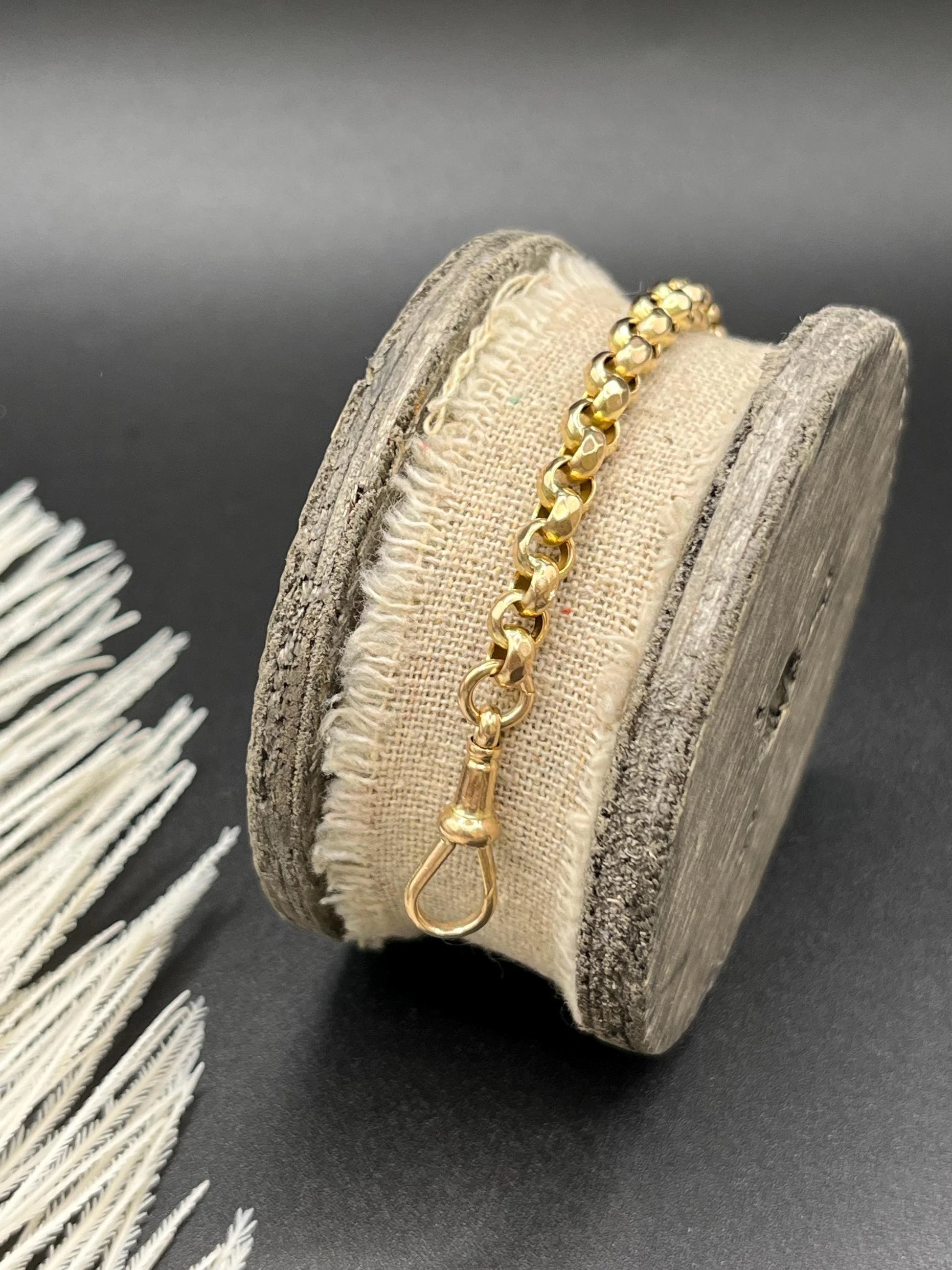 A yellow gold round link bracelet with a lobster claw clasp
