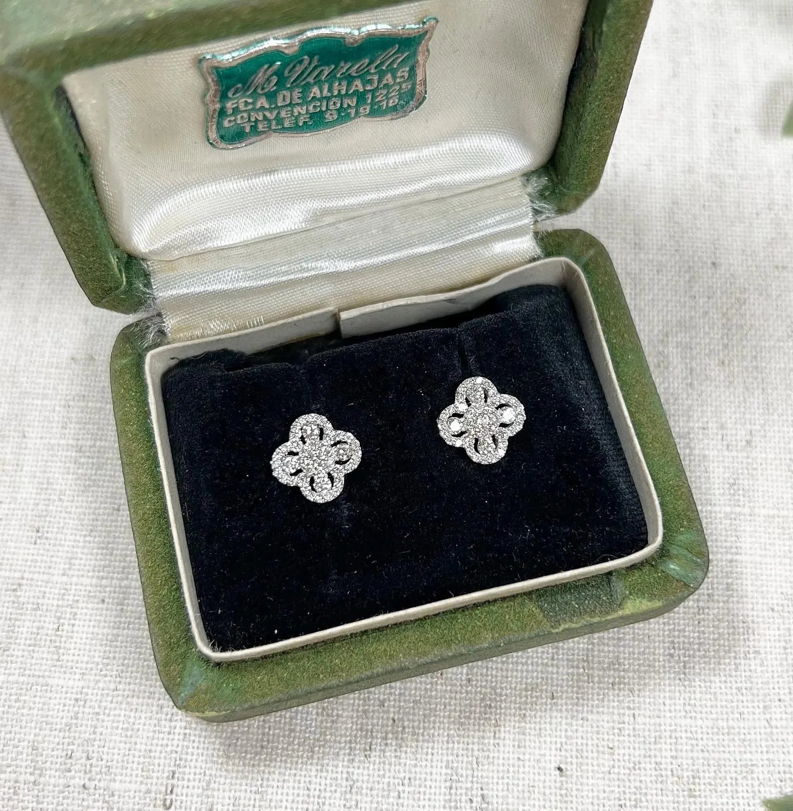 A pair of white gold clover shaped diamond cluster stud earrings, in a box