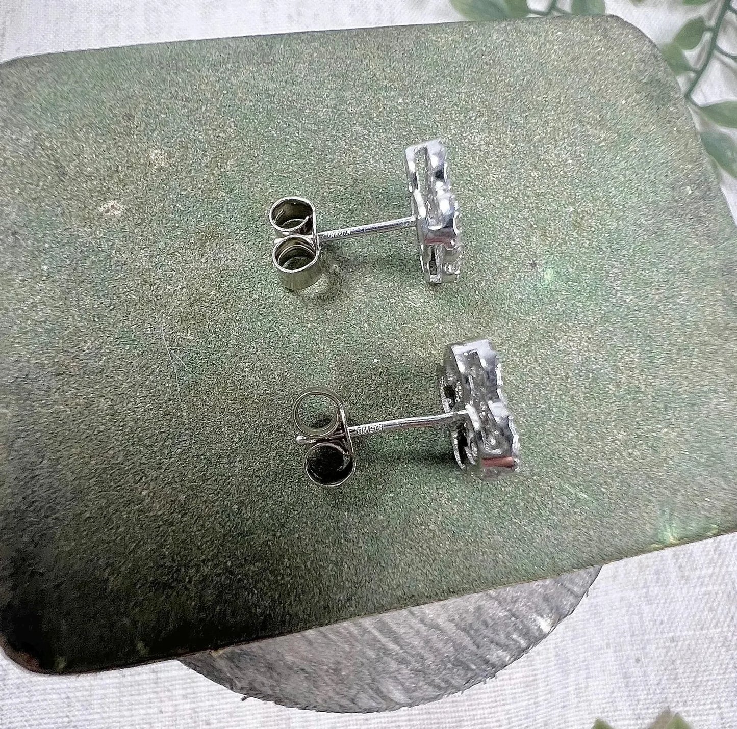 A pair of white gold clover shaped diamond cluster stud earrings