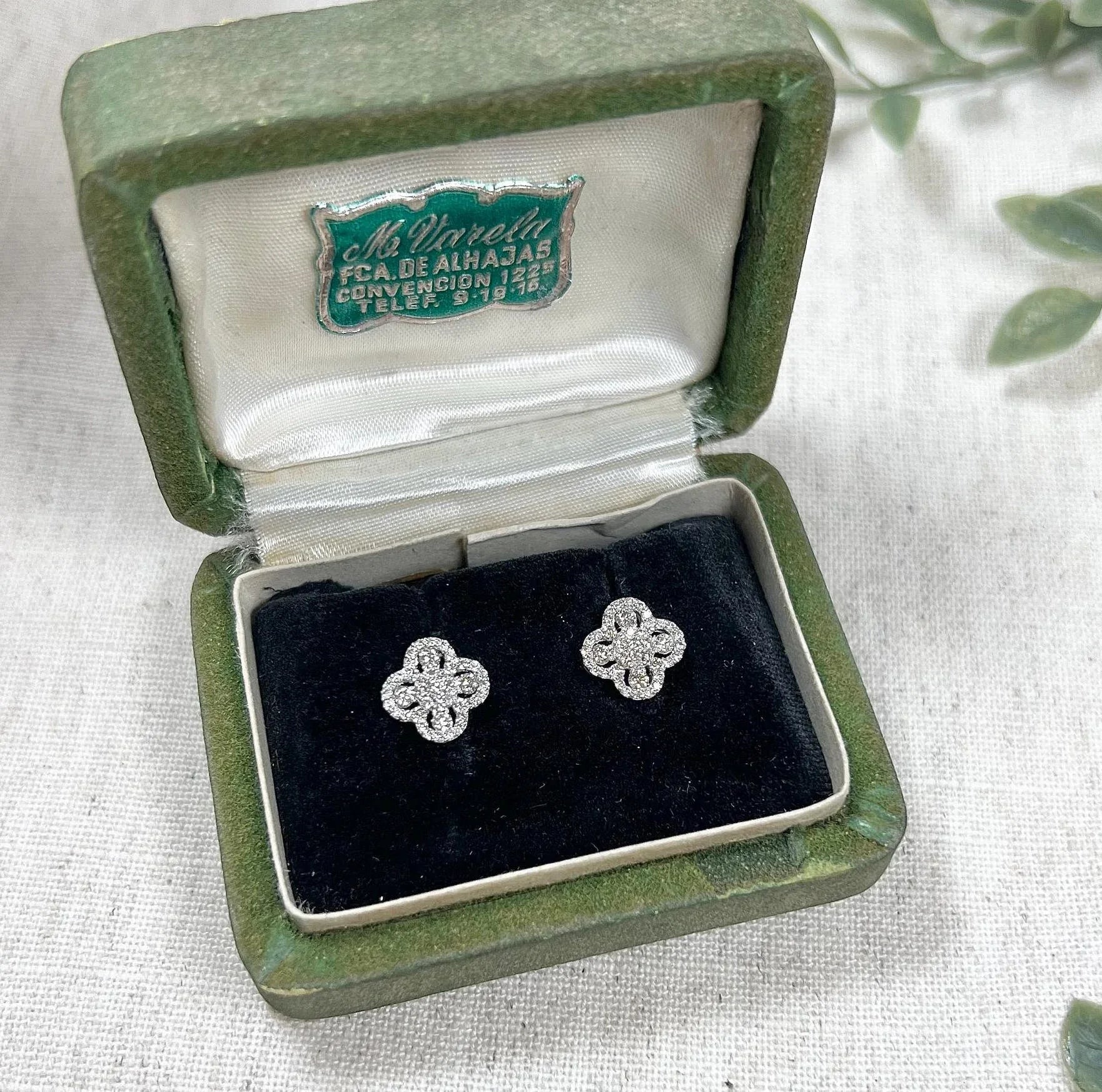 A pair of white gold clover shaped diamond cluster stud earrings, in a box
