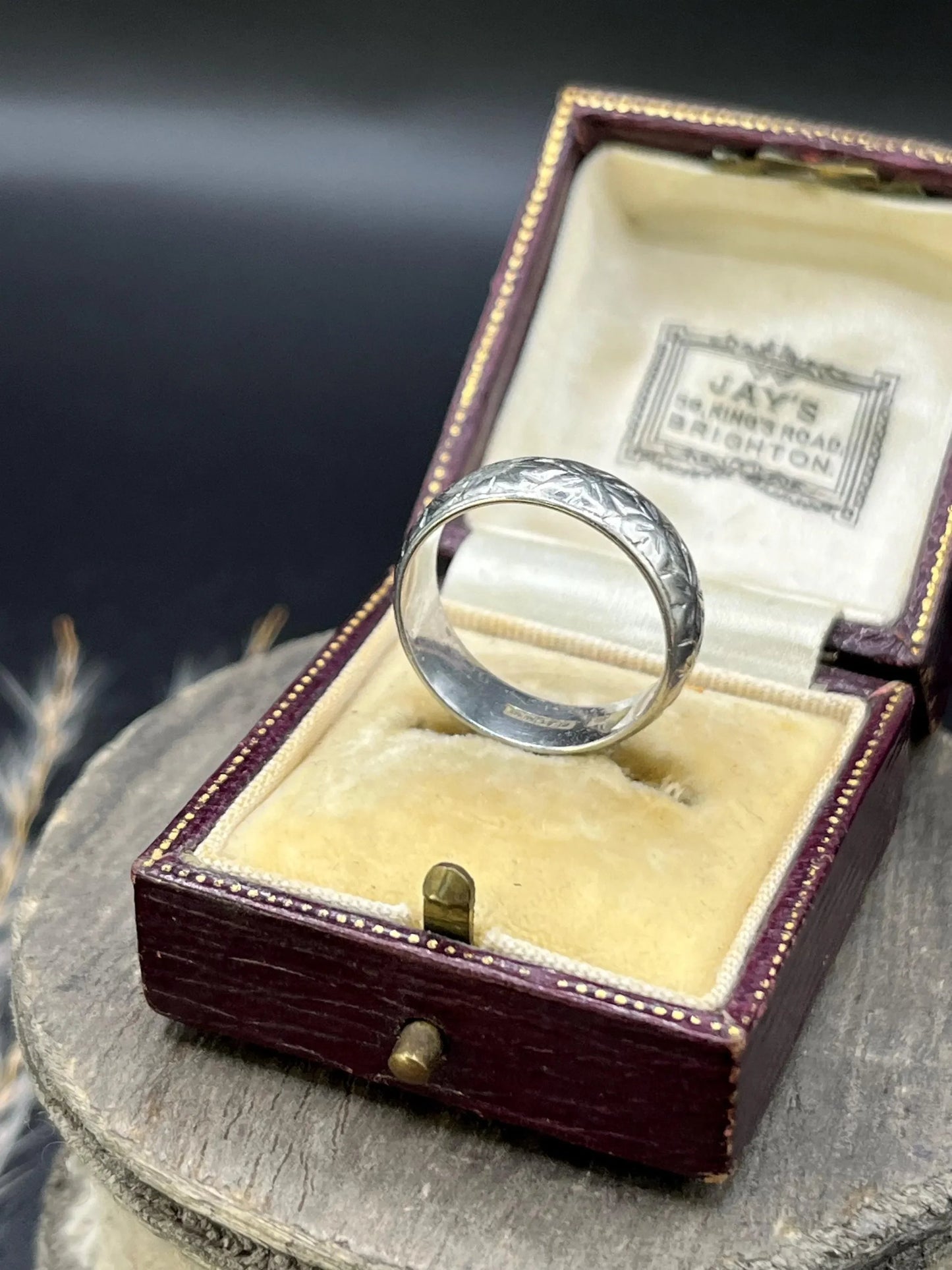 An engraved platinum wedding band ring, in an antique ring box