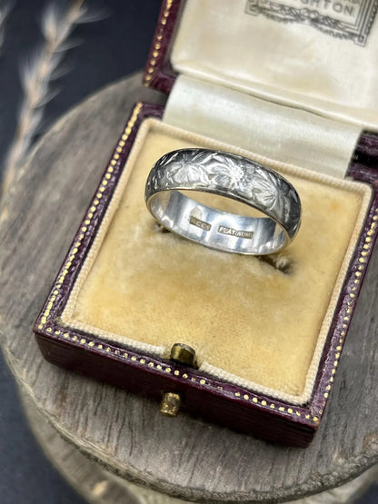 An engraved platinum wedding band ring, in an antique ring box