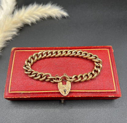 A rose gold curb link bracelet with engraved heart padlock clasp