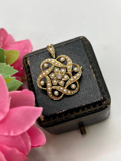 A yellow gold seed pearl and diamond floral brooch/pendant