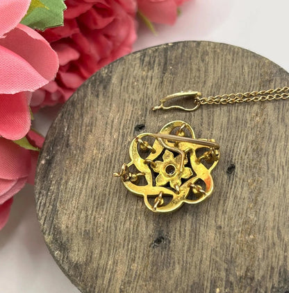 A yellow gold seed pearl and diamond floral brooch/pendant, with a gold chain