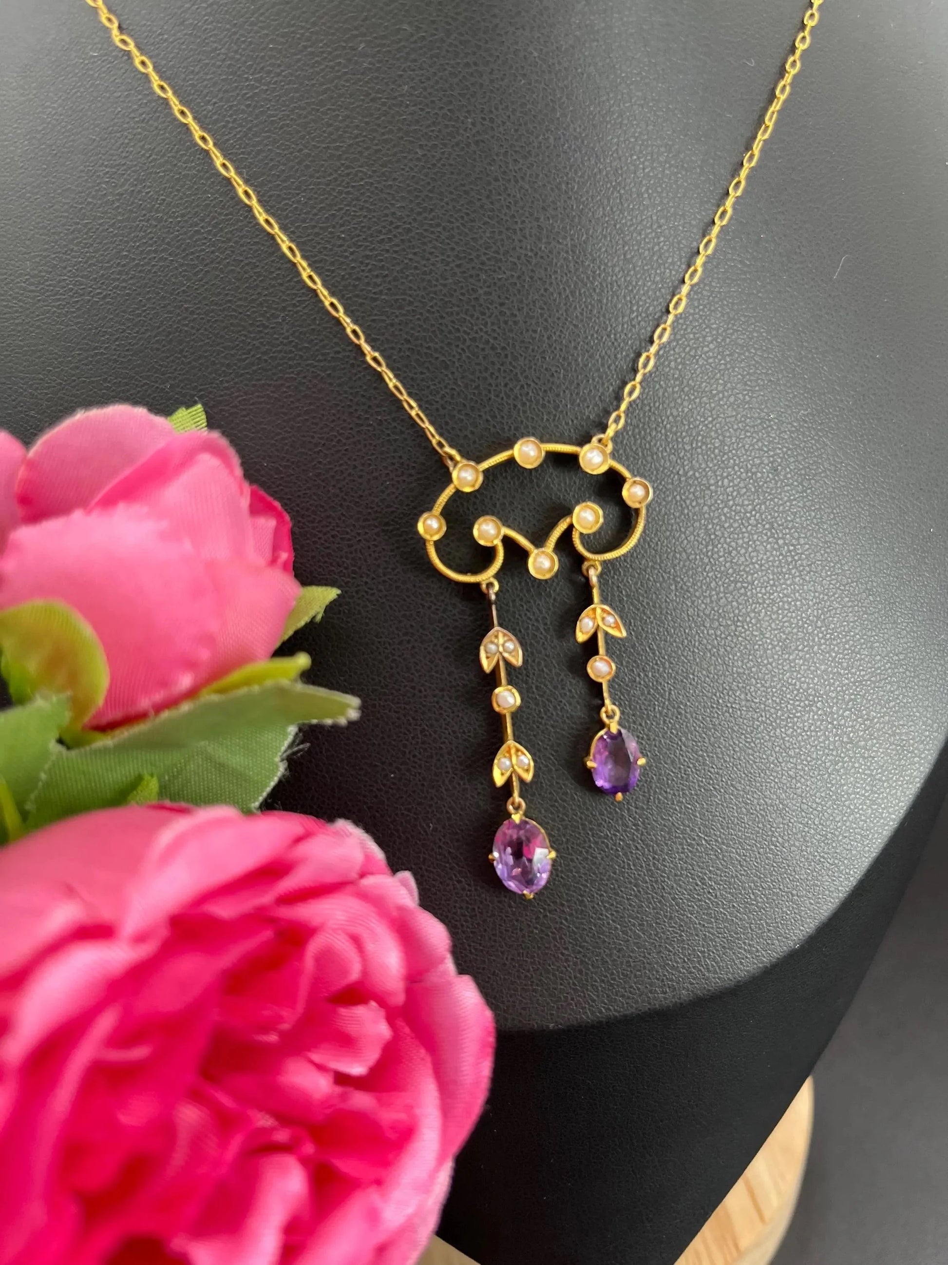 An amethyst and seed pearl drop pendant necklace in yellow gold
