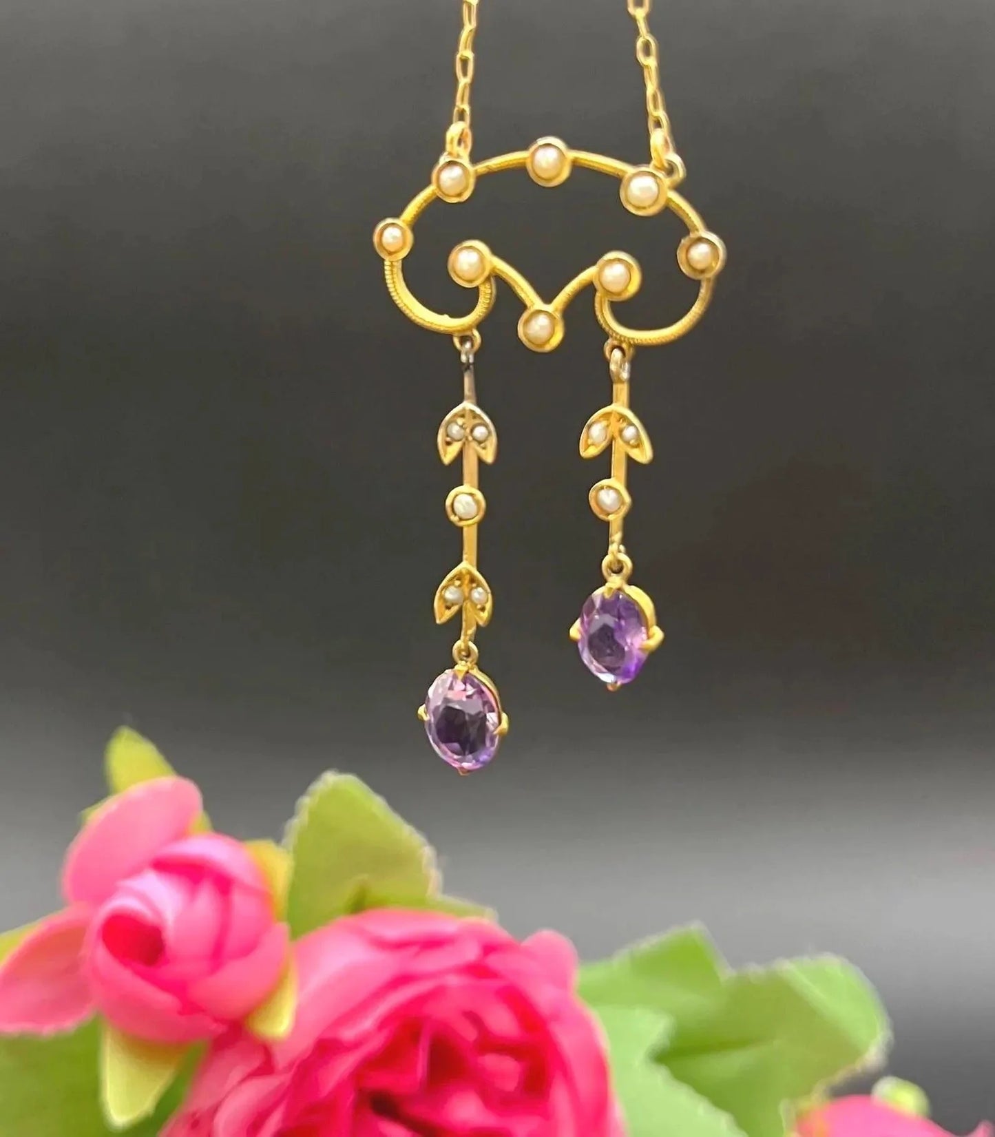 An amethyst and seed pearl drop pendant necklace in yellow gold