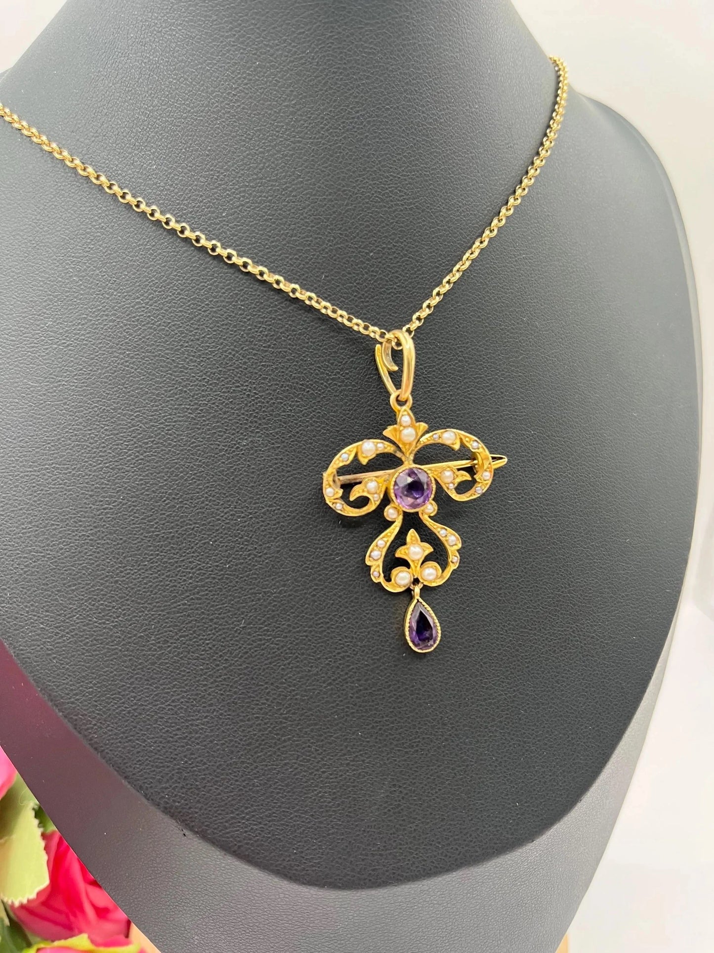A yellow gold amethyst and seed pearl pendant/brooch, with a gold chain