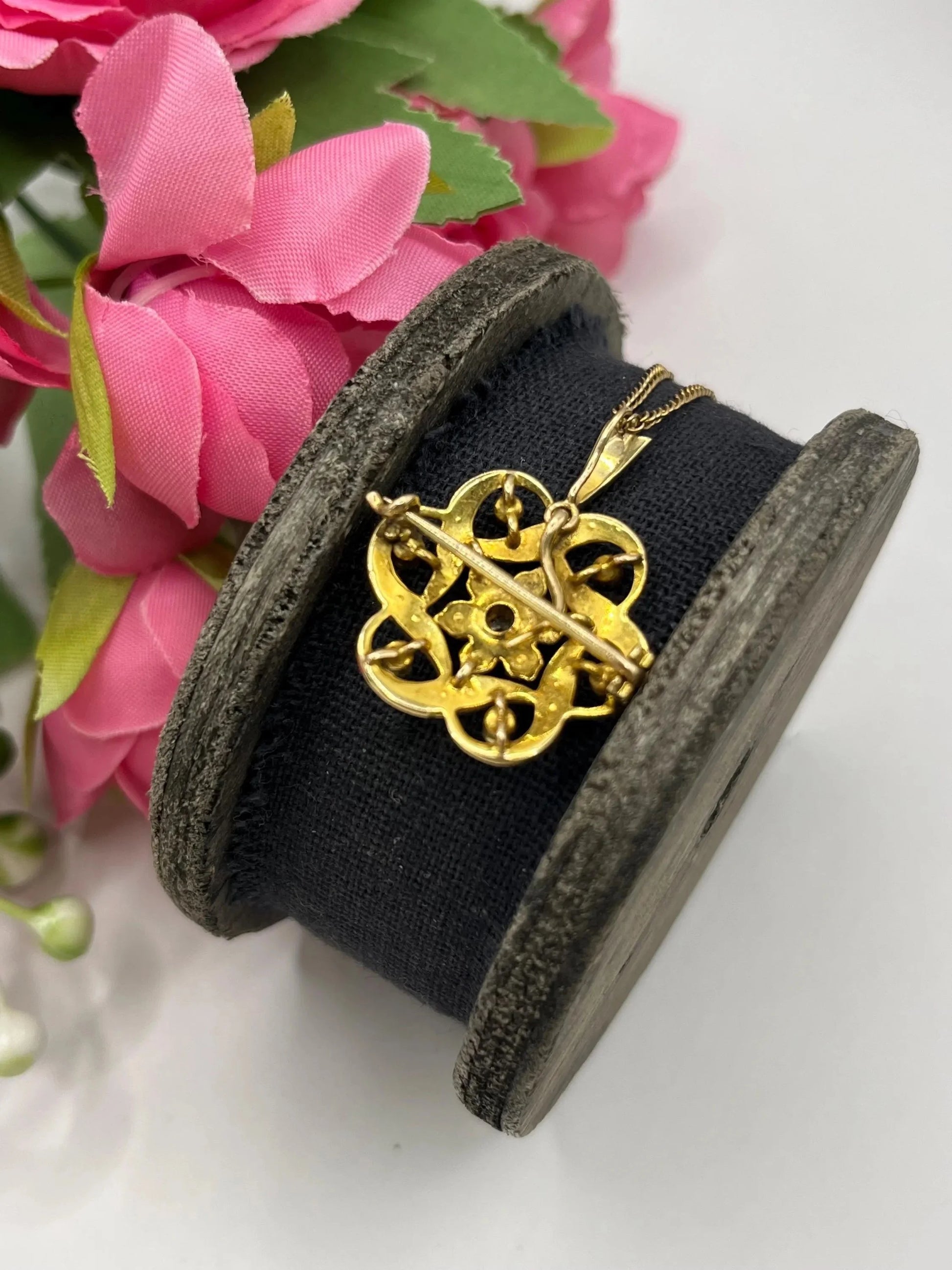 A yellow gold seed pearl and diamond floral brooch/pendant, with a chain