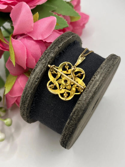 A yellow gold seed pearl and diamond floral brooch/pendant, with a chain