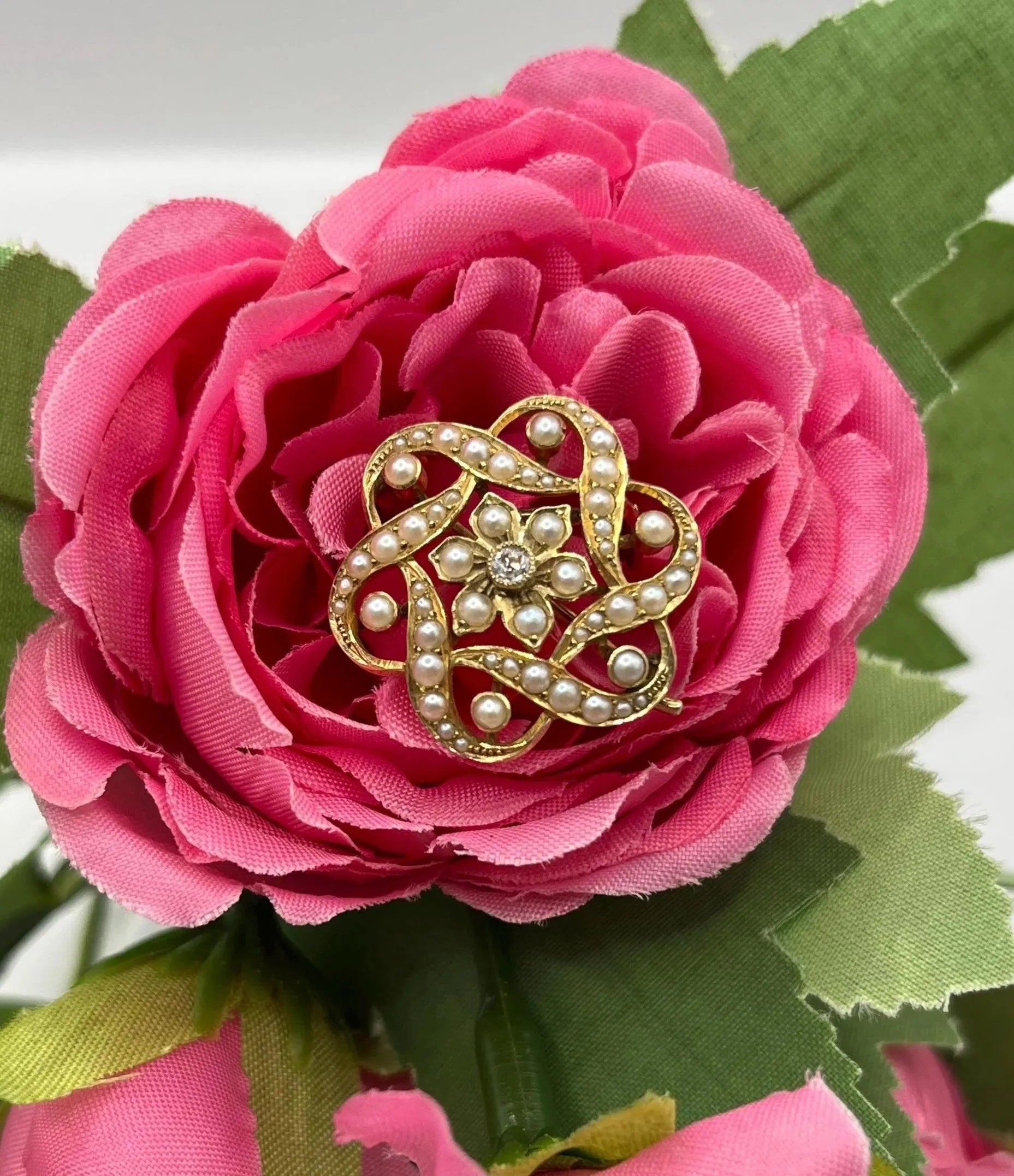 A yellow gold seed pearl and diamond floral brooch/pendant