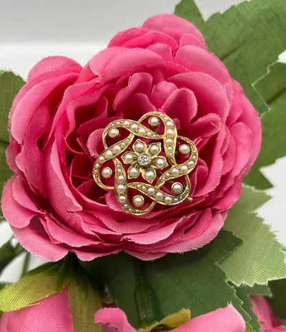 A yellow gold seed pearl and diamond floral brooch/pendant