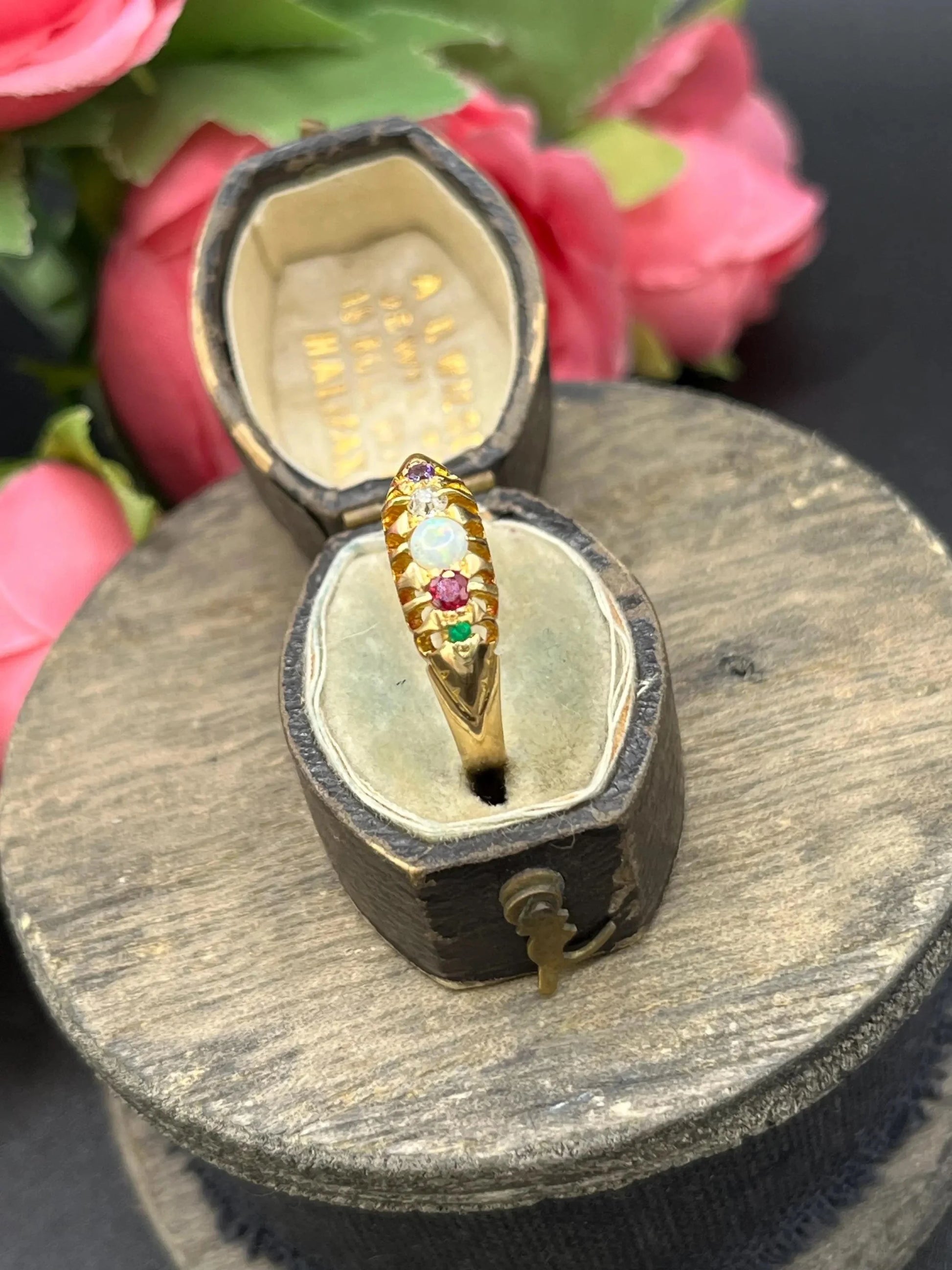 A yellow gold multi-gemstone acrostic ring, in an antique ring box