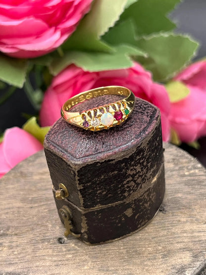A yellow gold multi-gemstone acrostic ring, in an antique ring box