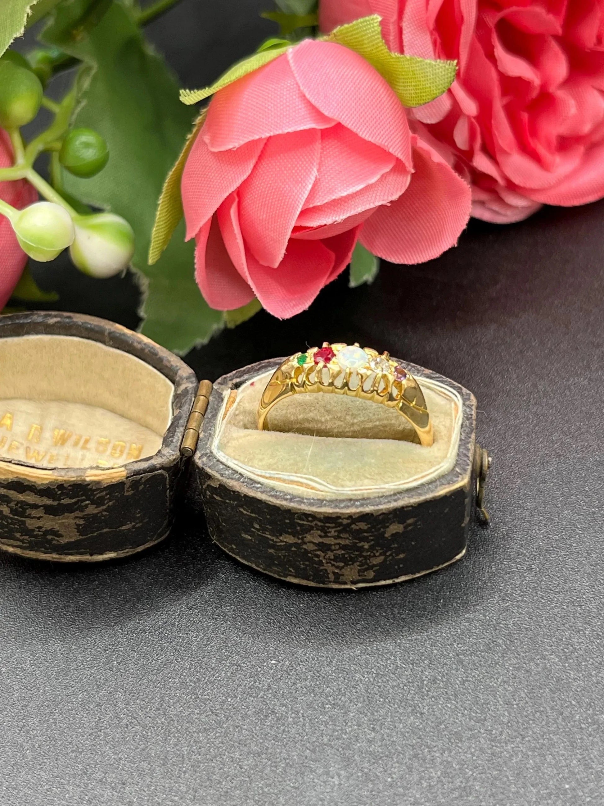 A yellow gold multi-gemstone acrostic ring, in an antique ring box