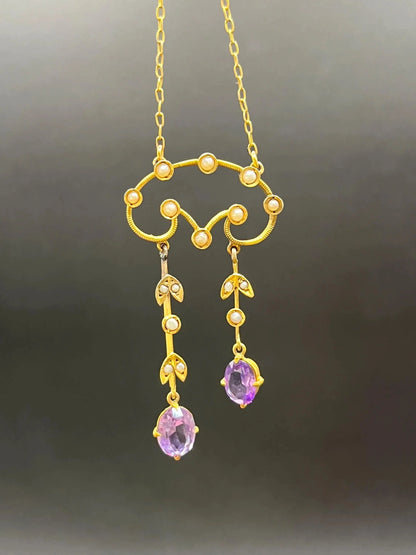 An amethyst and seed pearl drop pendant necklace in yellow gold