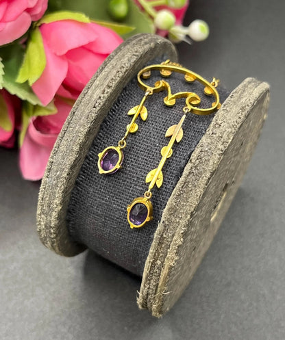 An amethyst and seed pearl drop pendant necklace in yellow gold
