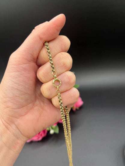 A yellow gold belcher link chain necklace, held in a hand