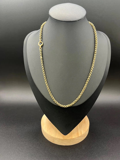 A yellow gold belcher link chain necklace, on a black jewellery bust