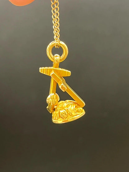 A yellow gold faith, hope and charity fob, with a gold chain